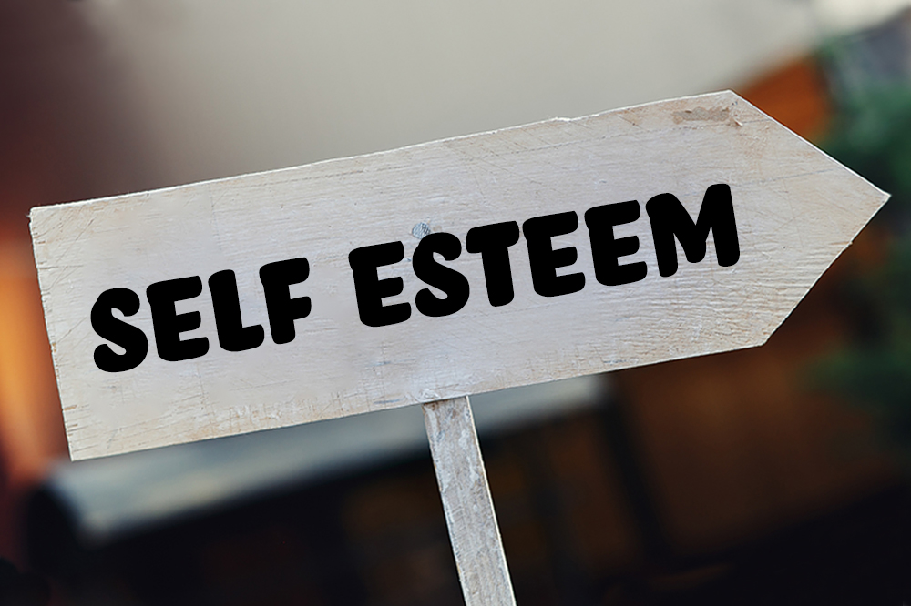 white wooden arrow that says self esteem
